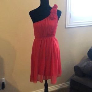 One shoulder coral dress.